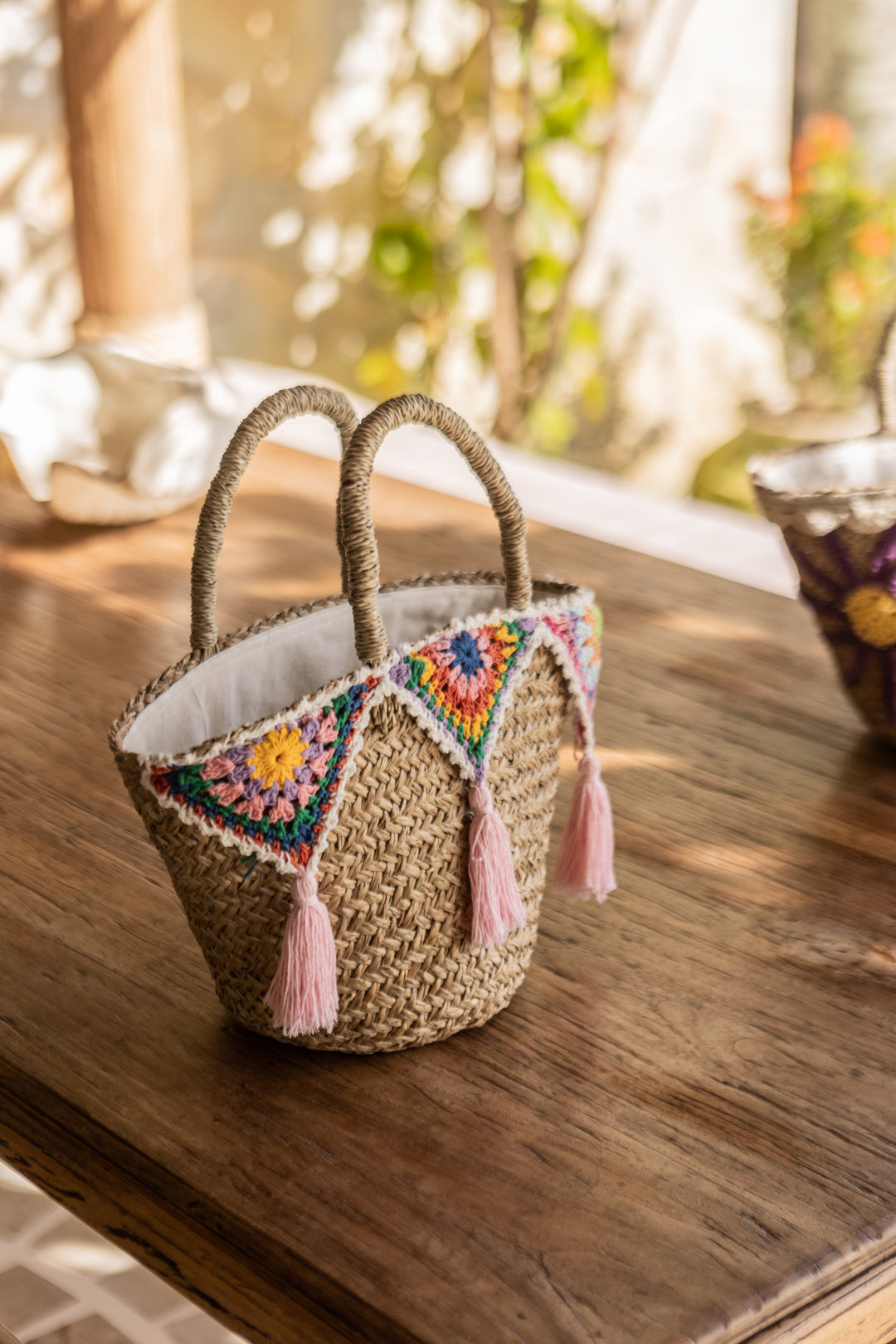 Small colorful wicker bag with fringe